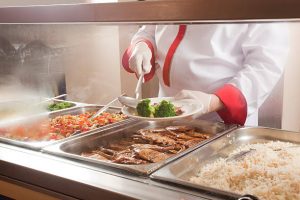 chef standing behind full lunch service station